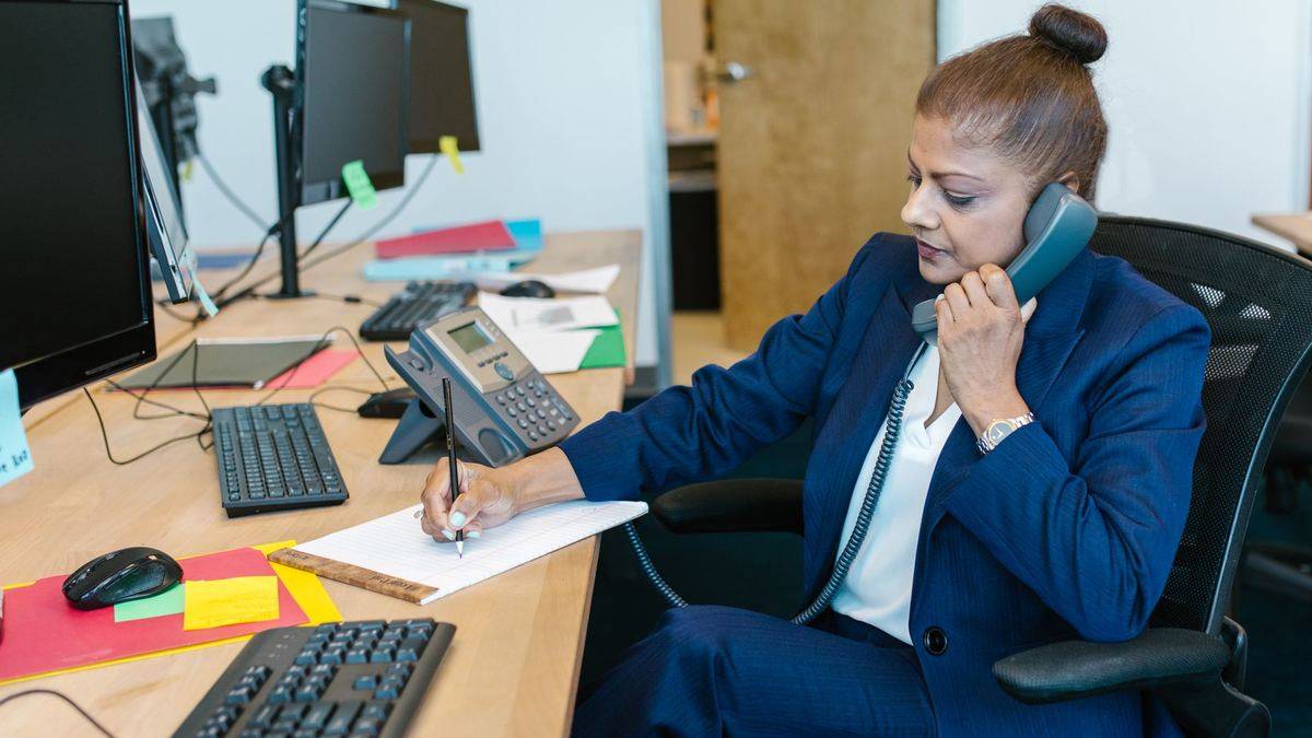 Operations executive on a call at a bank office desk